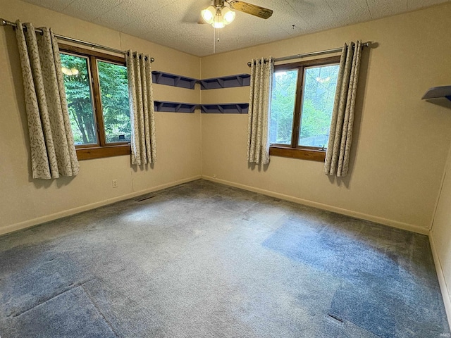 spare room featuring carpet floors, a ceiling fan, baseboards, and visible vents