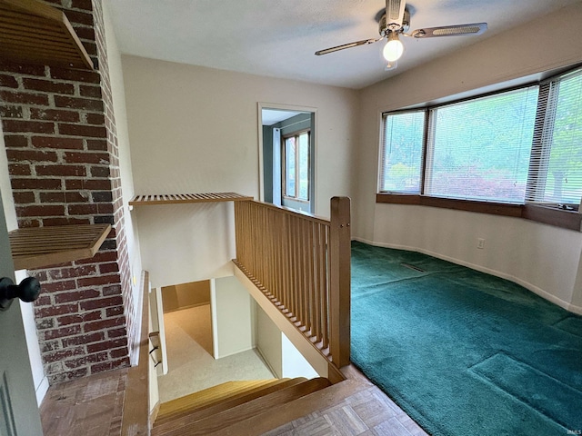 stairway with baseboards, a ceiling fan, and carpet floors