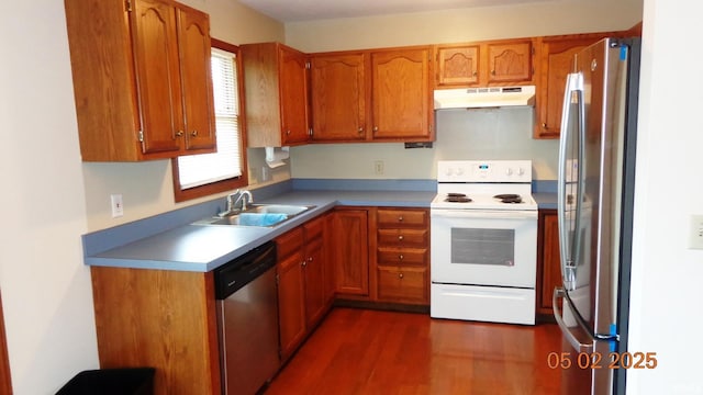 4214 Hunters Trce, Evansville, IN 47715 - kitchen featuring dark wood-style floors, under cabinet range hood, brown cabinets, a sink, and appliances with stainless steel finishes