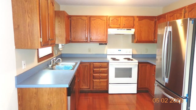 4214 Hunters Trce, Evansville, IN 47715 - kitchen featuring a sink, brown cabinetry, stainless steel appliances, dark wood-type flooring, and under cabinet range hood