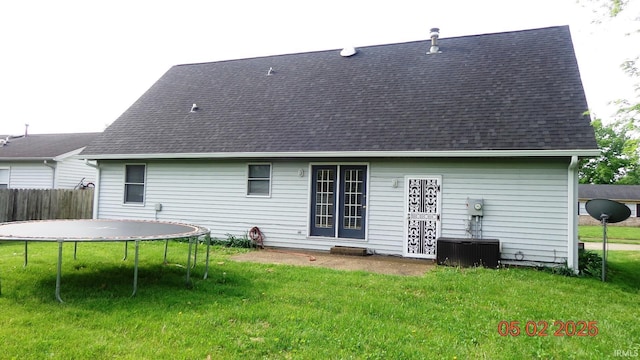 4214 Hunters Trce, Evansville, IN 47715 - rear view of property with roof with shingles, fence, a trampoline, central AC, and a yard