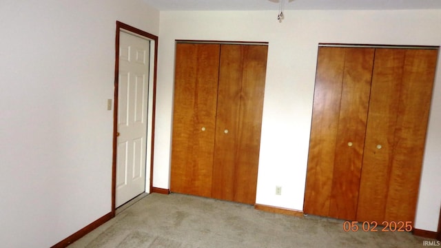 4214 Hunters Trce, Evansville, IN 47715 - unfurnished bedroom featuring carpet floors, baseboards, and multiple closets