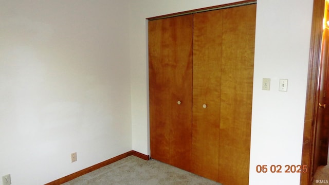 4214 Hunters Trce, Evansville, IN 47715 - unfurnished bedroom with a closet, baseboards, and light carpet