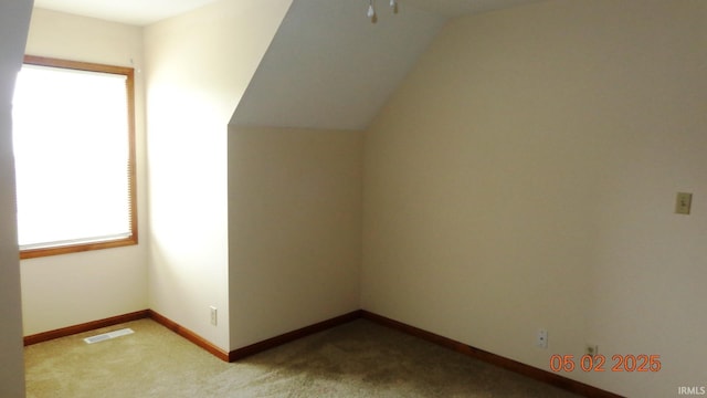 4214 Hunters Trce, Evansville, IN 47715 - additional living space with baseboards, visible vents, light carpet, and lofted ceiling