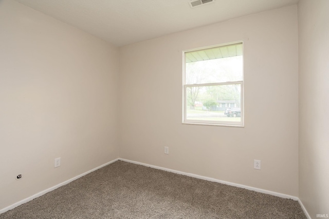 carpeted empty room with baseboards and visible vents