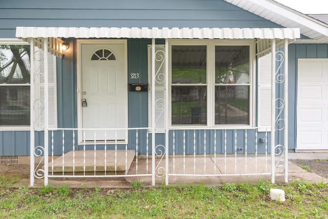 view of exterior entry featuring covered porch