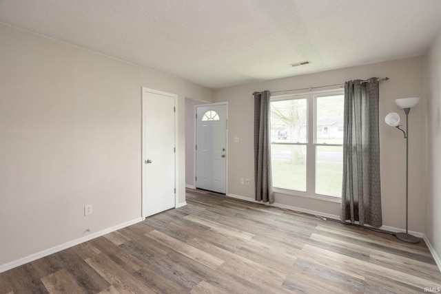 interior space featuring visible vents, baseboards, and light wood-type flooring