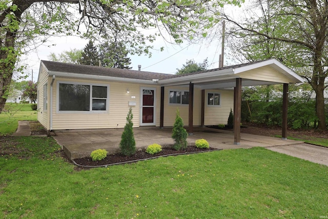 1421 E Ireland Rd, South Bend, IN 46614 - view of front of property featuring roof with shingles, a front yard, and a carport