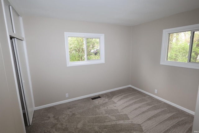1421 E Ireland Rd, South Bend, IN 46614 - carpeted spare room featuring baseboards, visible vents, and a wealth of natural light
