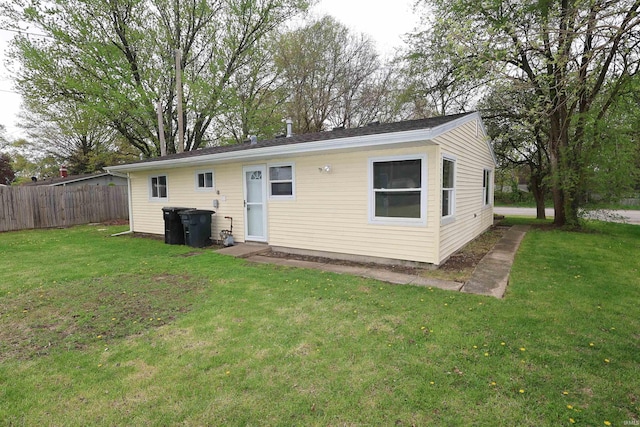 1421 E Ireland Rd, South Bend, IN 46614 - rear view of property with a lawn and fence