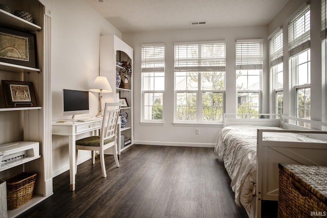 bedroom featuring baseboards, visible vents, and dark wood-type flooring