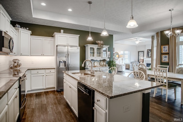 kitchen featuring a sink, a raised ceiling, white cabinetry, dark wood-style floors, and black appliances