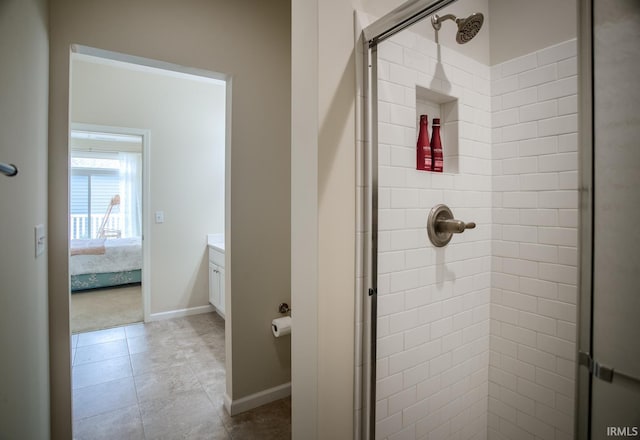 full bath with vanity, baseboards, a shower stall, and tile patterned flooring