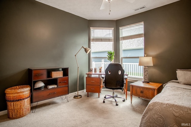 bedroom with baseboards, ceiling fan, light carpet, and visible vents