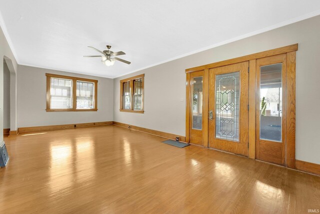 entrance foyer featuring crown molding and a wealth of natural light