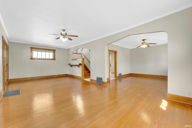unfurnished living room with stairway, ceiling fan, visible vents, and light wood finished floors