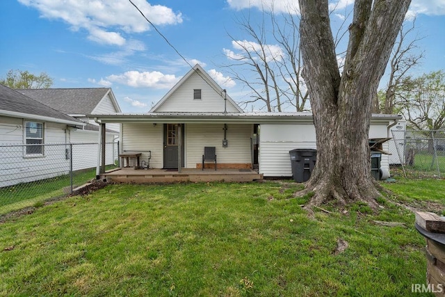 730 S Bell St, Kokomo, IN 46902 - rear view of property featuring fence, covered porch, and a lawn