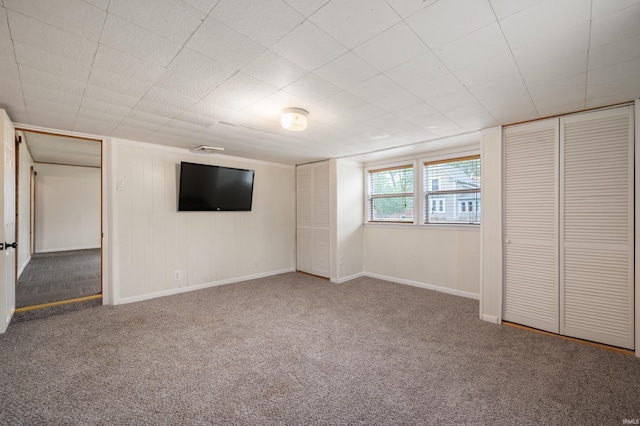 unfurnished bedroom with baseboards and carpet flooring