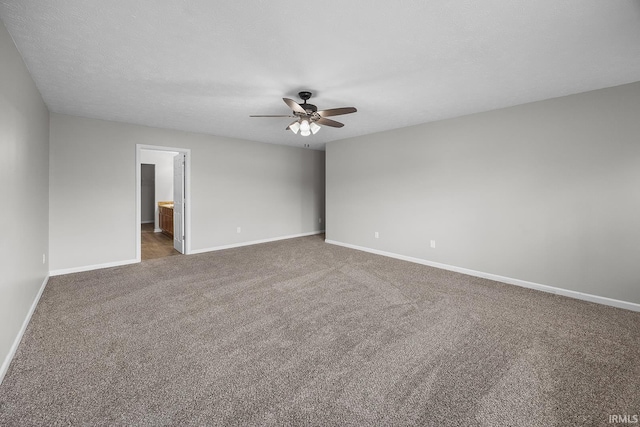 empty room featuring baseboards, a ceiling fan, and carpet flooring