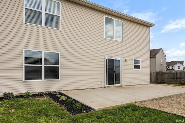 back of property with a patio area, fence, and a yard