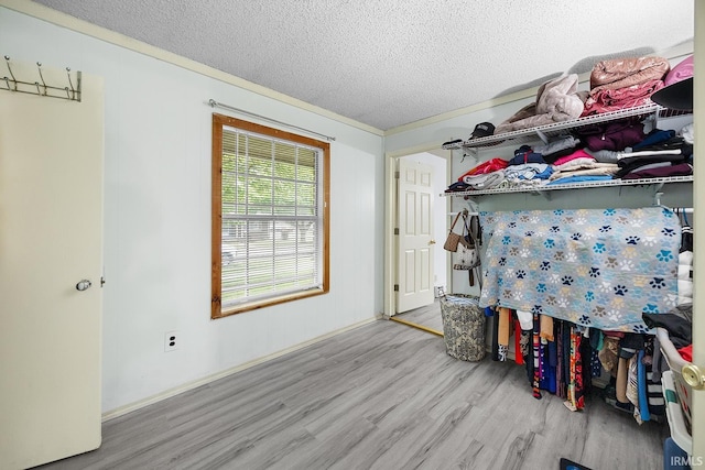 bedroom with a textured ceiling and wood finished floors