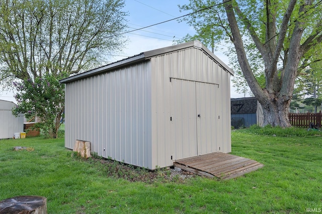 view of shed featuring fence