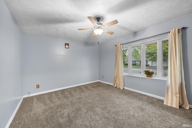 empty room with baseboards, carpet, a ceiling fan, and a textured ceiling