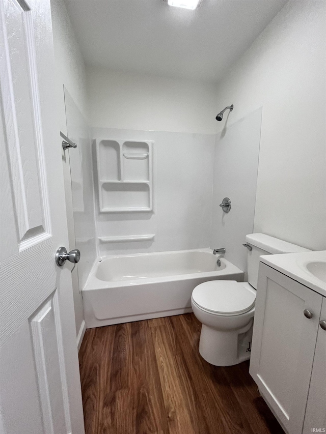 full bath featuring toilet, shower / bath combination, wood finished floors, and vanity