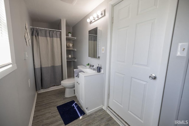 bathroom featuring vanity, toilet, baseboards, curtained shower, and wood finished floors