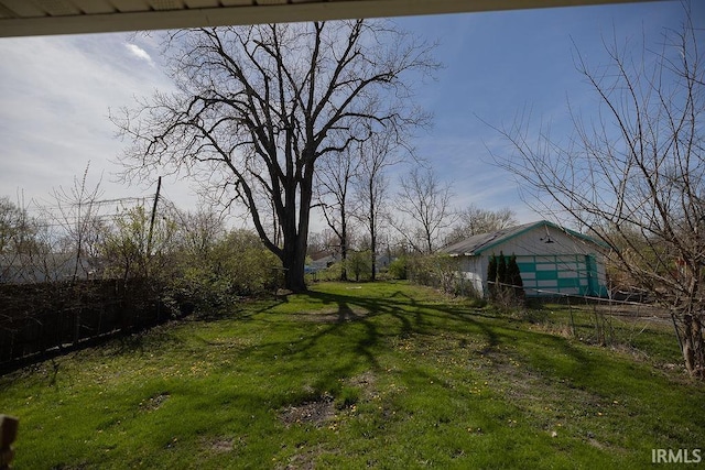 view of yard featuring a garage and fence