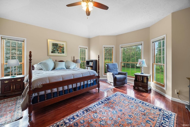 bedroom with a ceiling fan, baseboards, and hardwood / wood-style flooring