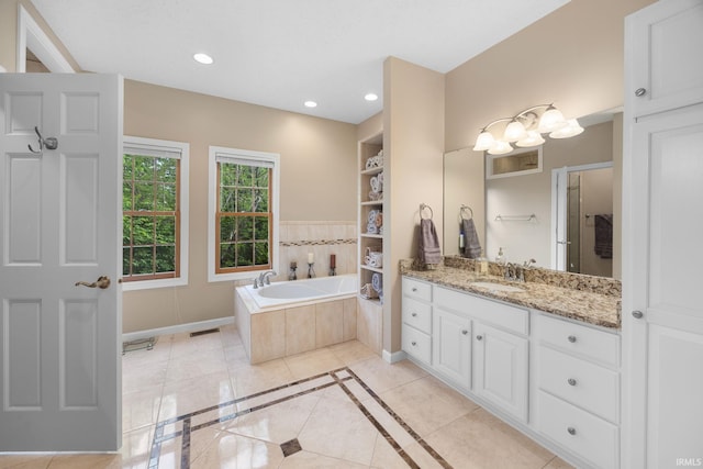 bathroom featuring vanity, baseboards, recessed lighting, tile patterned floors, and a bath