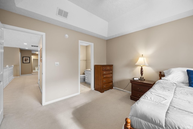 bedroom with baseboards, light carpet, a textured ceiling, and visible vents