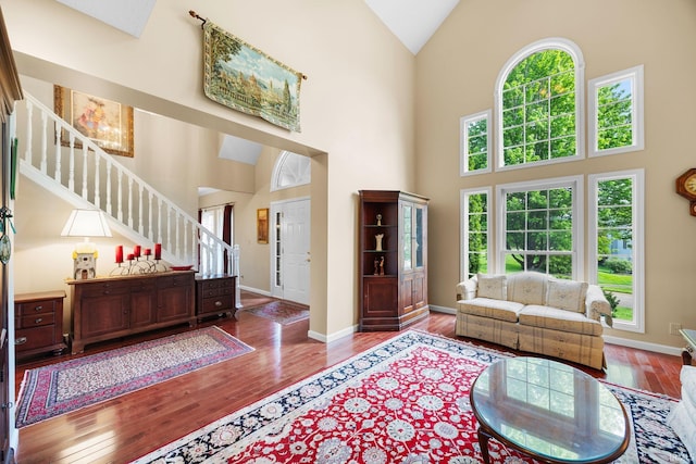 living area featuring stairs, wood finished floors, and a wealth of natural light