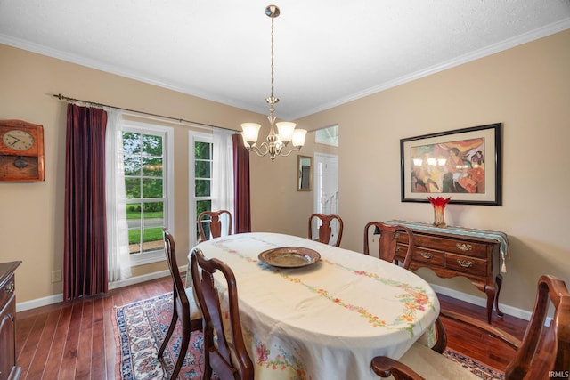 dining area featuring an inviting chandelier, baseboards, crown molding, and dark wood finished floors