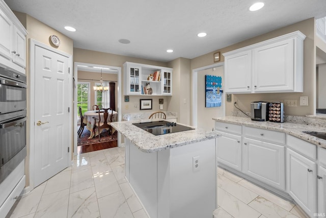 kitchen featuring white cabinets, open shelves, a notable chandelier, marble finish floor, and a kitchen island