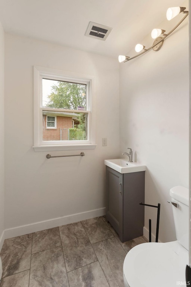 2031 Alton Dr, Kokomo, IN 46901 - half bathroom with visible vents, baseboards, toilet, and vanity