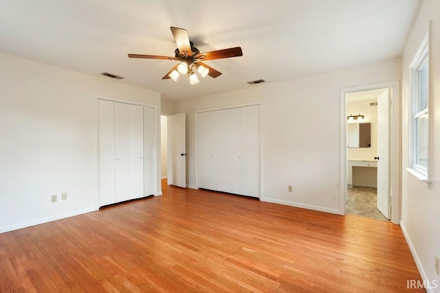 2031 Alton Dr, Kokomo, IN 46901 - unfurnished bedroom featuring two closets, light wood-style flooring, and visible vents