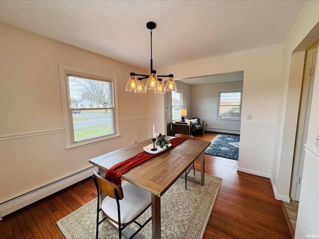 2031 Alton Dr, Kokomo, IN 46901 - dining area with a chandelier, wood finished floors, and baseboard heating