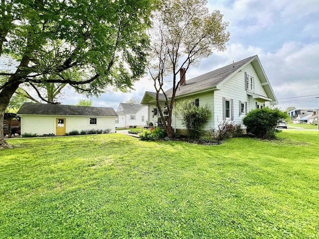rear view of property with a lawn and a chimney