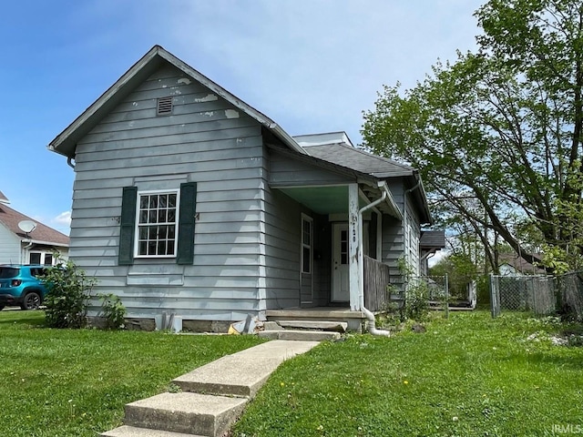 bungalow-style house featuring fence and a front yard