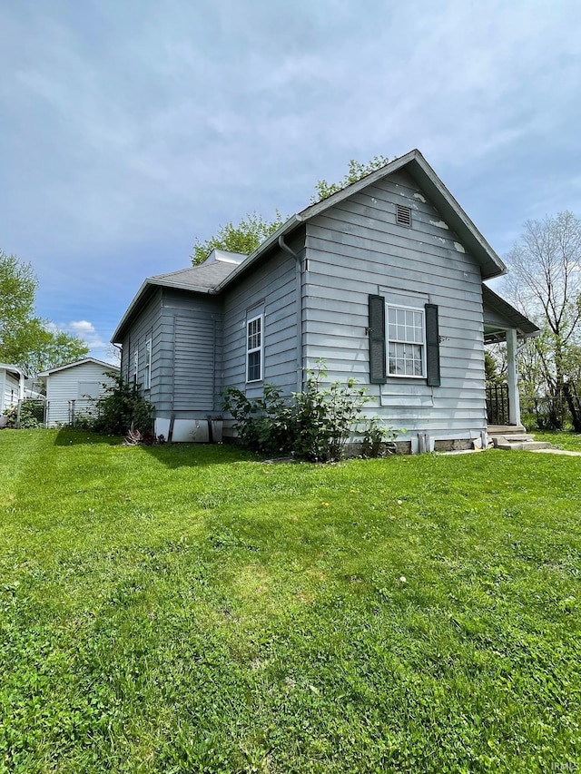 view of side of property with a lawn