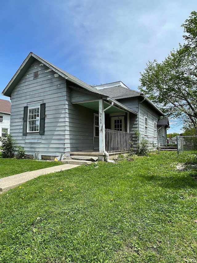 single story home with a front lawn and fence