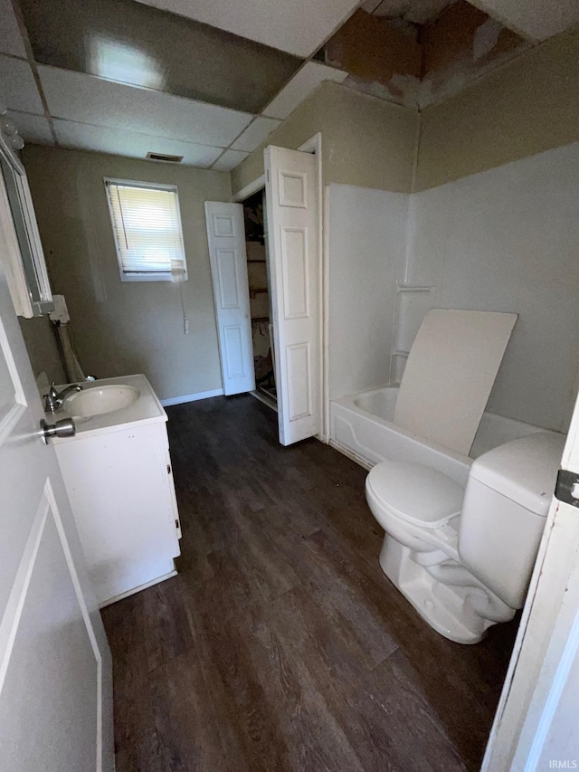 bathroom featuring toilet, visible vents, wood finished floors, and vanity