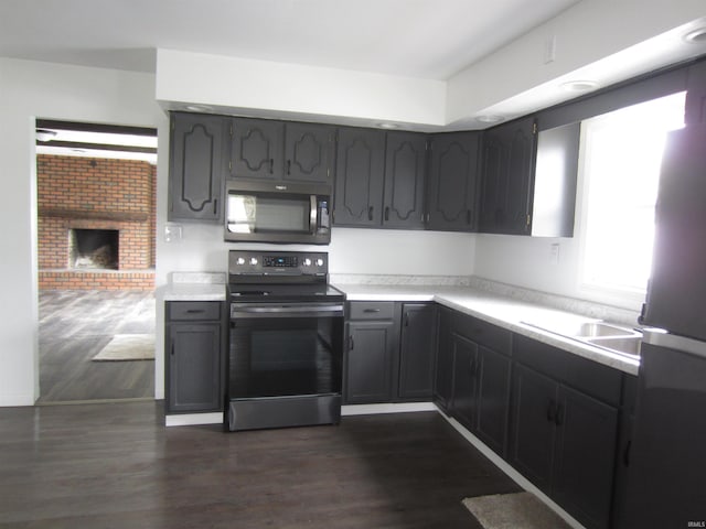 kitchen with light countertops, dark wood finished floors, and stainless steel appliances