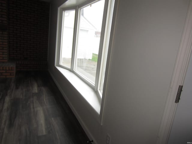 unfurnished room featuring baseboards and dark wood finished floors