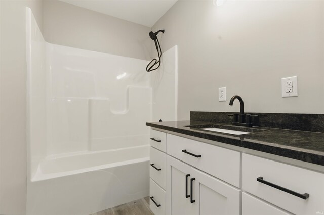 1724 28th St, Bedford, IN 47421 - full bathroom with vanity, bathtub / shower combination, and wood finished floors