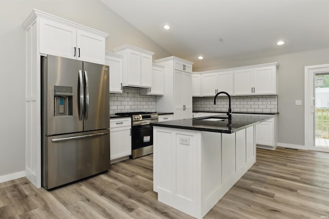 1724 28th St, Bedford, IN 47421 - kitchen featuring appliances with stainless steel finishes, a sink, dark countertops, white cabinetry, and recessed lighting