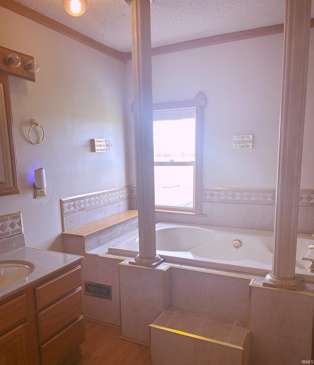 full bathroom featuring vanity, ornate columns, and a textured ceiling