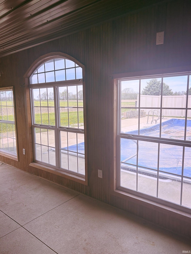 doorway to outside featuring wood walls
